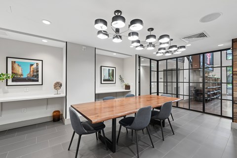 A conference room with a long table and chairs.