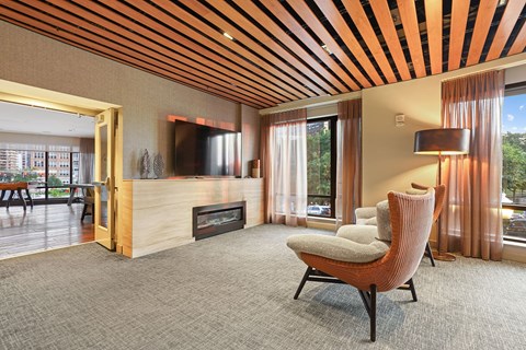 a living room with a chair and a fireplace