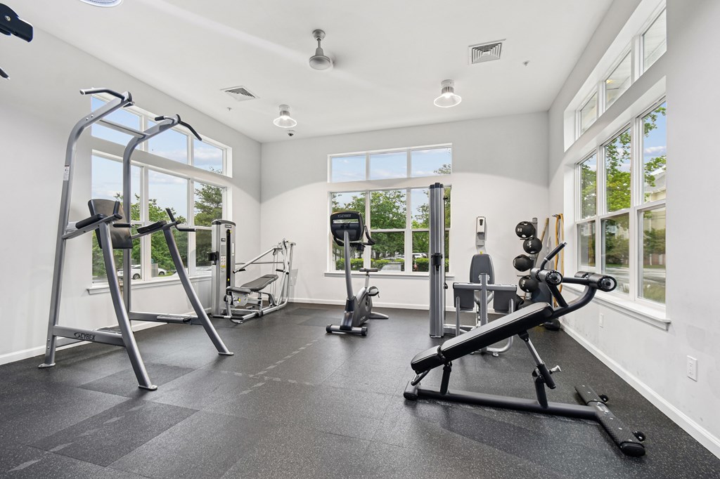 A spacious home gym with a variety of exercise equipment.