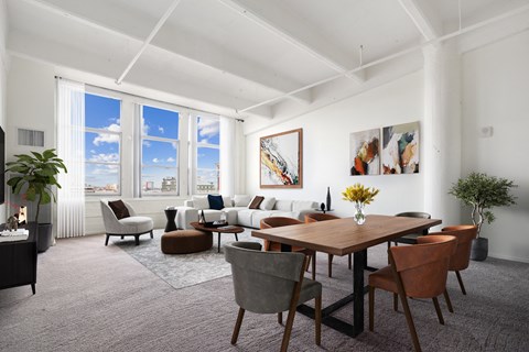 A living room with a large table and chairs.