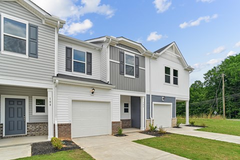 A two-story house with a garage on the first floor.