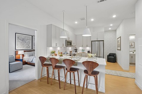 A modern kitchen with a dining table and chairs.