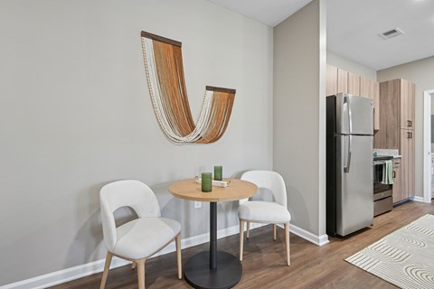 A modern dining room with a wooden table and chairs.