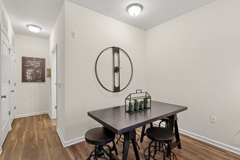 A dining room with a table and chairs.