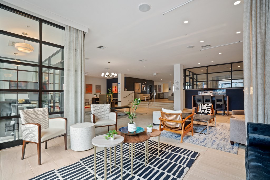 a living room filled with furniture and a large window