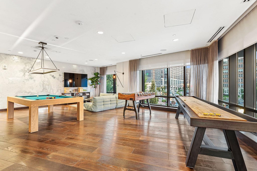 a game room with a pool table and a billiard table