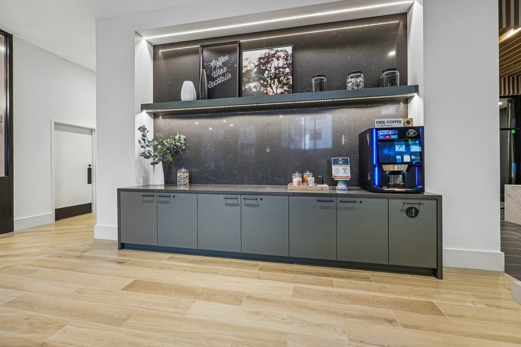 a coffee machine sits on a gray counter in a lobby