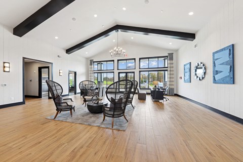 A large room with wooden floors and a long table with chairs.