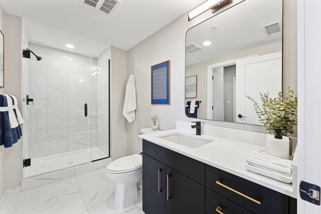 A bathroom with a white toilet and a white sink.
