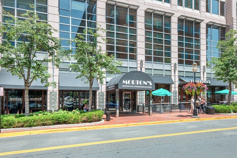 a city street with a large building in the background