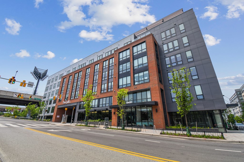 A modern multi-story building with a black and red facade.