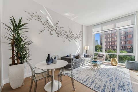 A modern dining room with a white table and chairs.
