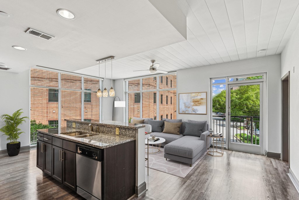 a living room with a kitchen and a sliding glass door