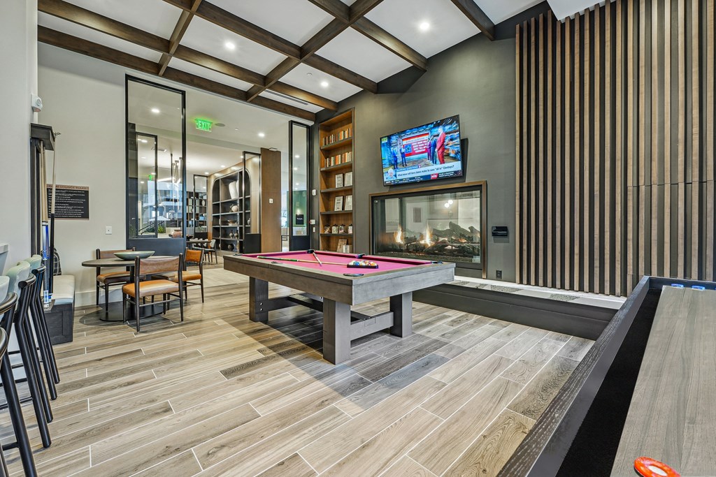 a game room with a pool table and a tv