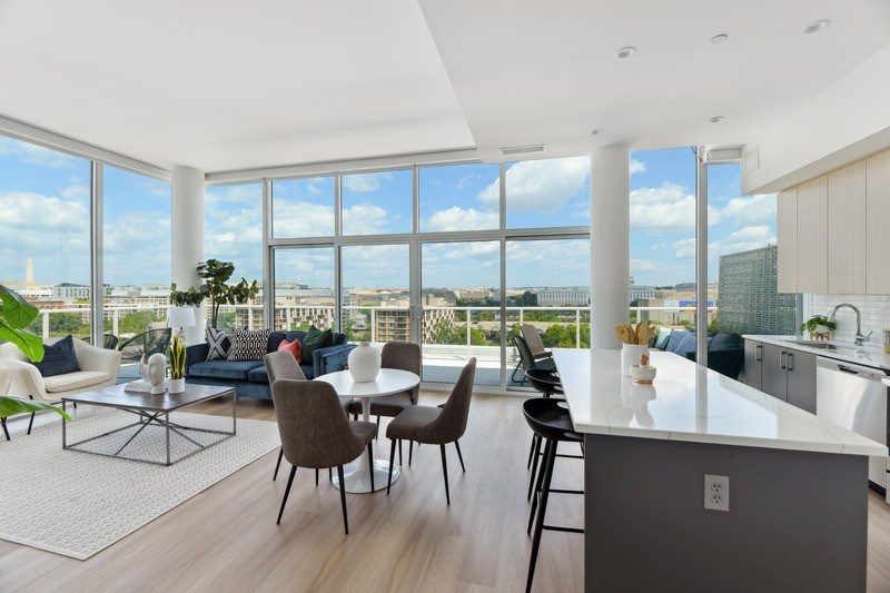 A modern kitchen and living room with a view of the city.