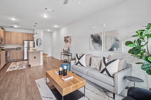 A living room with a grey couch and a coffee table.