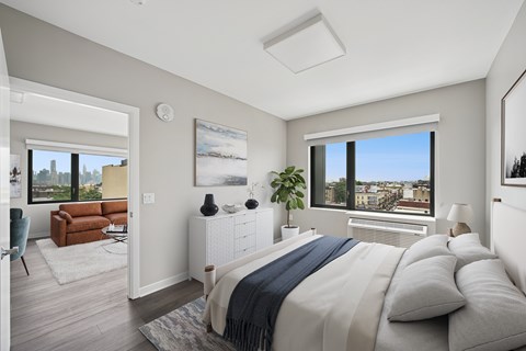 A bedroom with a large bed and a view of the city.