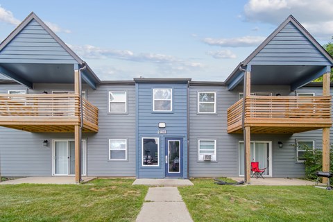 A two-story house with a balcony on each floor.