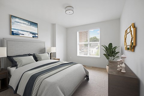 a bedroom with a large bed and a dresser with a plant on it