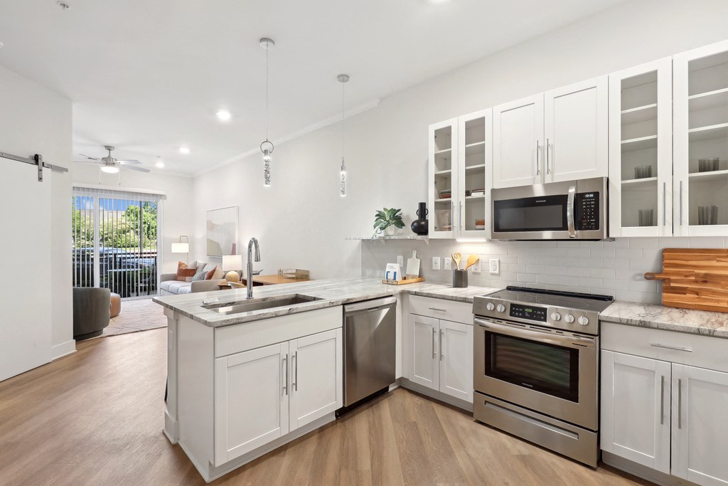 a kitchen with white cabinets and stainless steel appliances