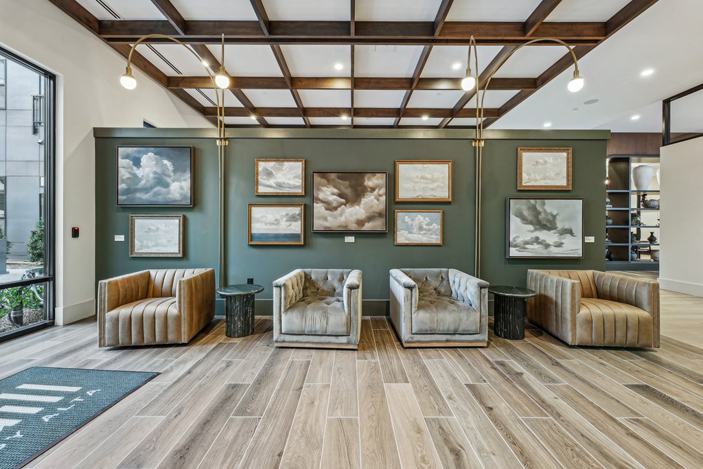 a living room with couches and pictures on the wall