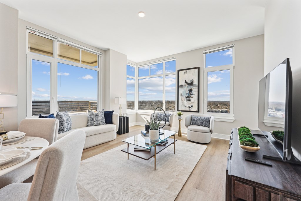 A living room with a couch, chairs, and a coffee table.