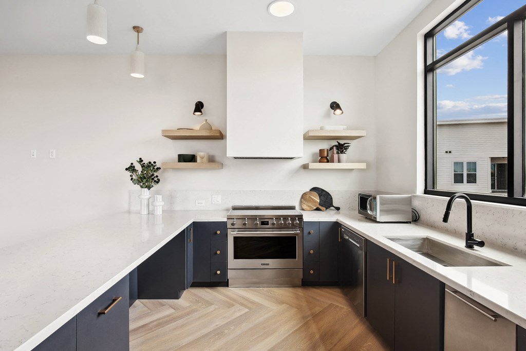 a kitchen with a sink and a large window