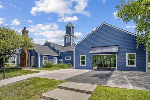 A blue building with a tower and a clock on the front.