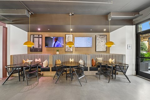 A modern dining area with a long table and chairs.