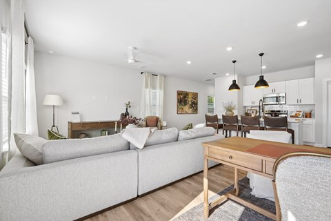 A modern living room with a grey sofa and a wooden coffee table.