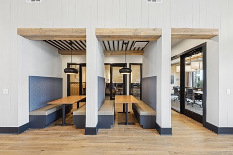 A long wooden table is in the middle of a room with a bench on each side.
