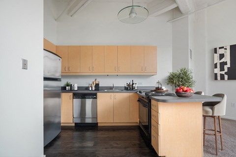 A modern kitchen with wooden cabinets and a large island.