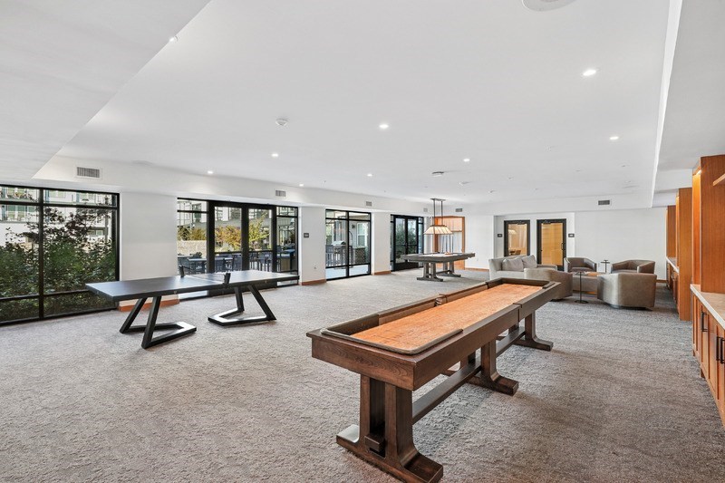A large room with a long wooden table and chairs.