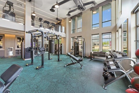an image of a fitness center with exercise equipment and windows