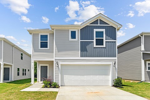 A modern two-story house with a garage.