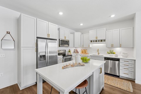 A white kitchen with a table and chairs.