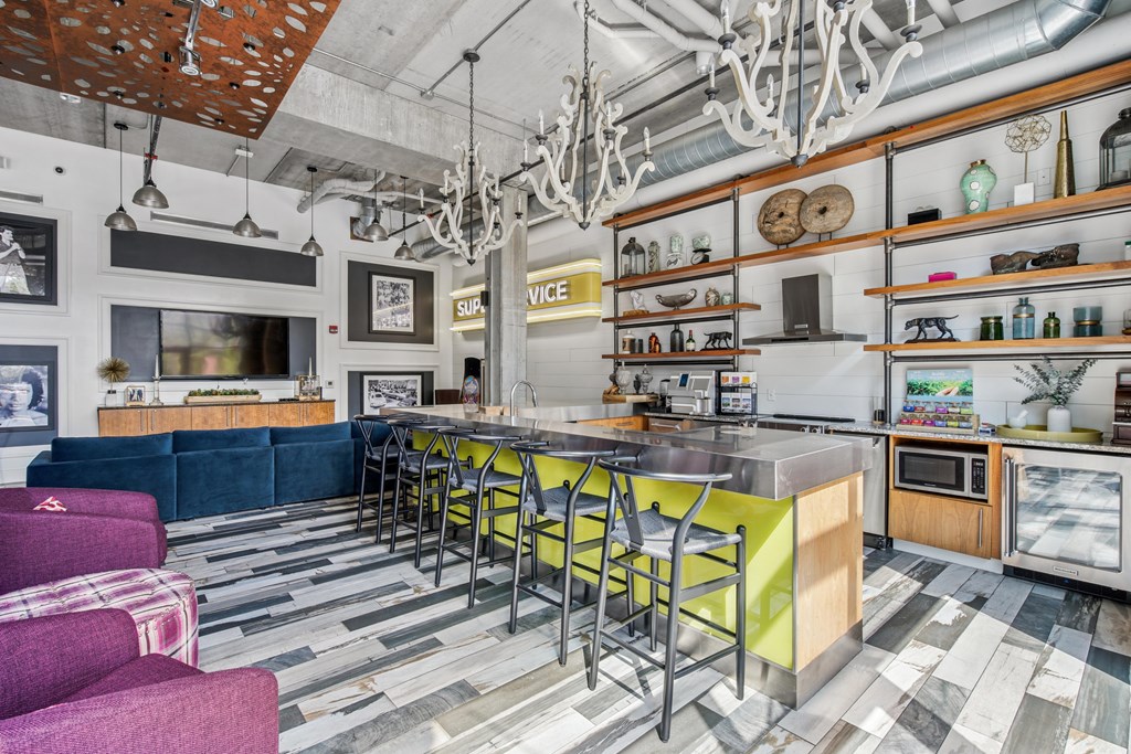 A kitchen with a blue couch and a yellow counter.