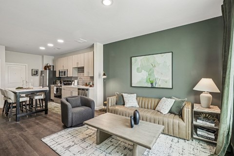 A modern living room with a grey sofa and a grey armchair.