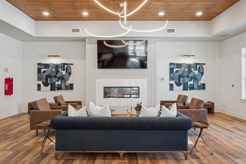 A modern living room with a large couch and a fireplace.