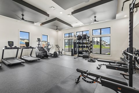A spacious home gym with a variety of exercise equipment.