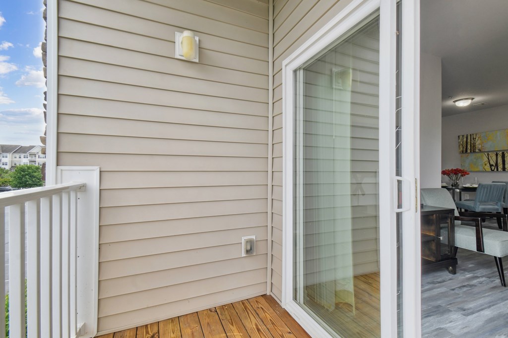 A patio door with a glass panel opens to a living room.