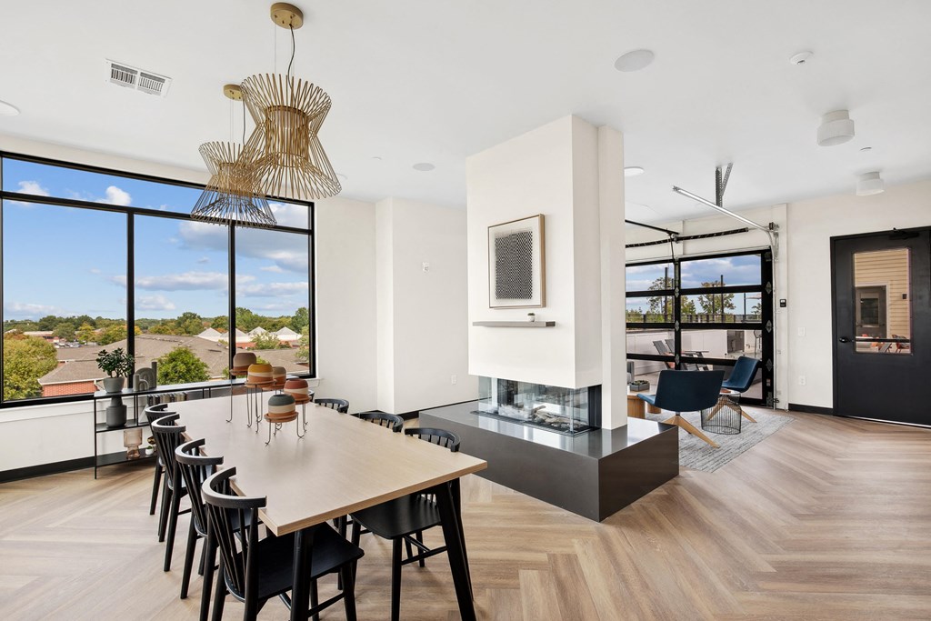 a dining room with a wooden table and chairs and a fireplace