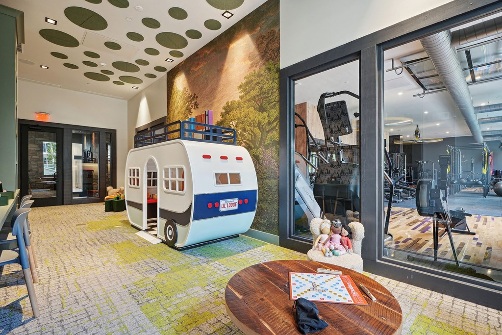 the lobby or reception area of a building with a toy caravan in the middle