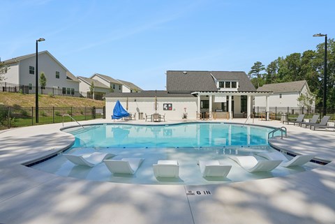 A swimming pool with a blue water feature in the middle of it.