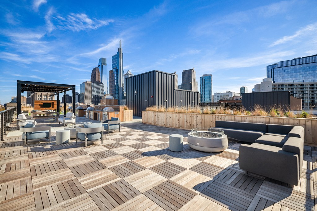 a roof deck with furniture and a view of the city