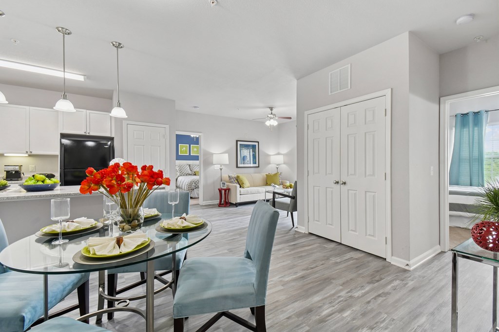 A dining room with a glass table and chairs.