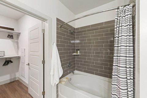 a bathroom with a bathtub and a shower curtain