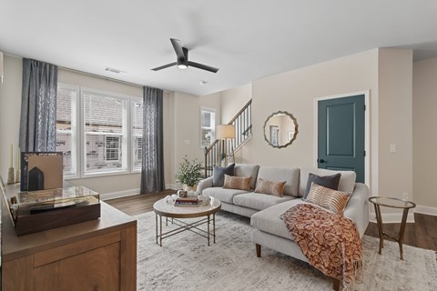 A living room with a grey couch and a wooden coffee table.