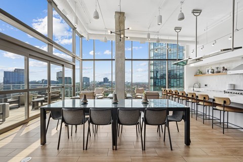A modern dining room with a glass table and chairs.
