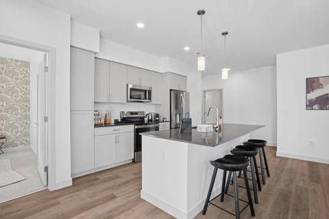 A modern kitchen with a bar stool.